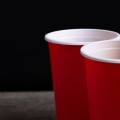 Are there any special rules for playing beer pong with different distances between teams and cups?