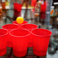 What are some common penalties or consequences associated with breaking the rules while playing a game of beer pong?