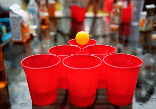 What are some common penalties or consequences associated with breaking the rules while playing a game of beer pong?